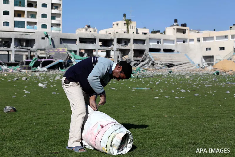 A Palestinian security guard works at a soccer stadium, which witnesses said was destroyed in an Israeli air strike during an eight-day conflict, in Gaza City December 4, 2012. Eight days of Israeli air strikes on Gaza a...