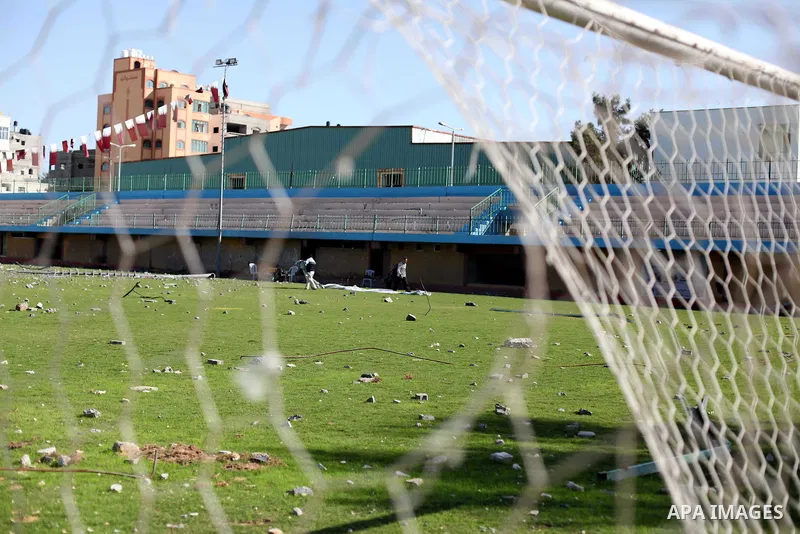 Palestinian security guards walk at a soccer stadium, which witnesses said was destroyed in an Israeli air strike during an eight-day conflict, in Gaza City December 4, 2012. Eight days of Israeli air strikes on Gaza and...