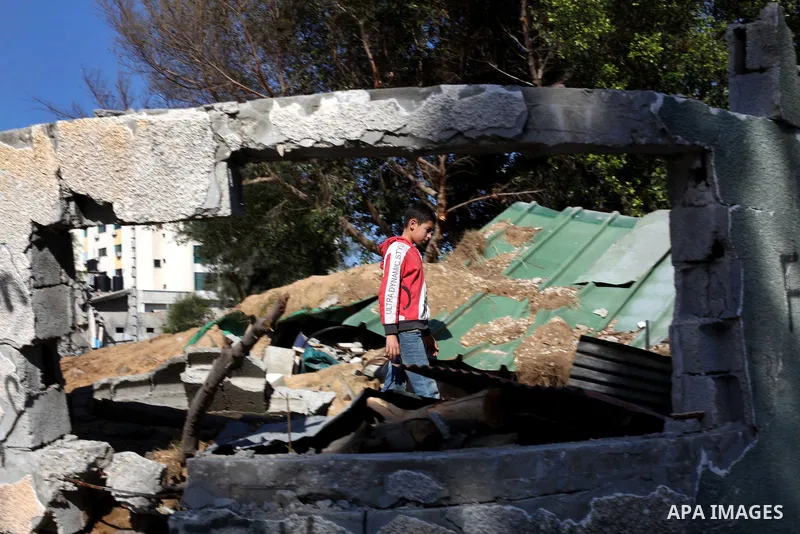 A Palestinian youth walks on the rubble at a soccer stadium, which witnesses said was destroyed in an Israeli air strike during an eight-day conflict, in Gaza City December 4, 2012. Eight days of Israeli air strikes on G...
