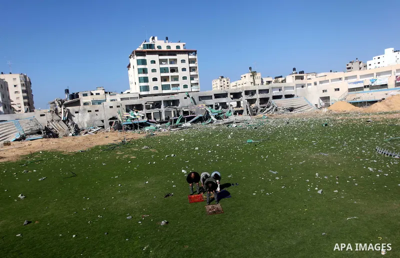 Palestinian security guards pray at a soccer stadium, which witnesses said was destroyed in an Israeli air strike during an eight-day conflict, in Gaza City December 4, 2012. Eight days of Israeli air strikes on Gaza and...