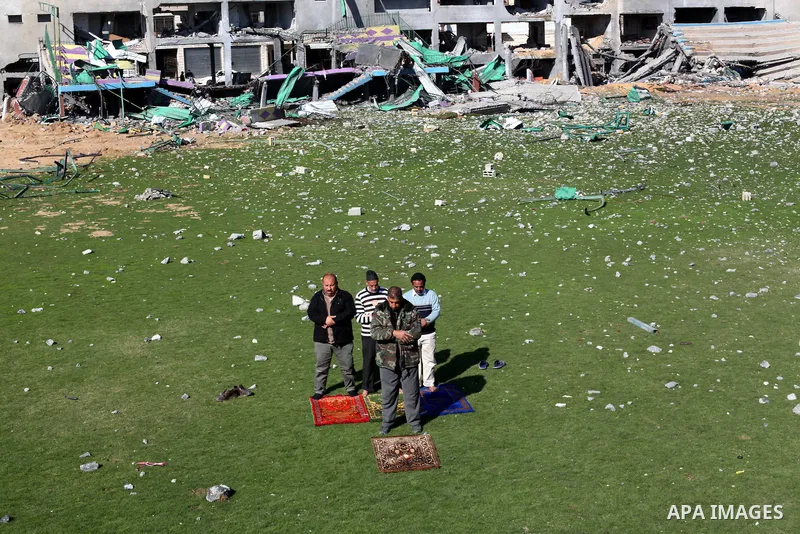 Palestinian security guards pray at a soccer stadium, which witnesses said was destroyed in an Israeli air strike during an eight-day conflict, in Gaza City December 4, 2012. Eight days of Israeli air strikes on Gaza and...