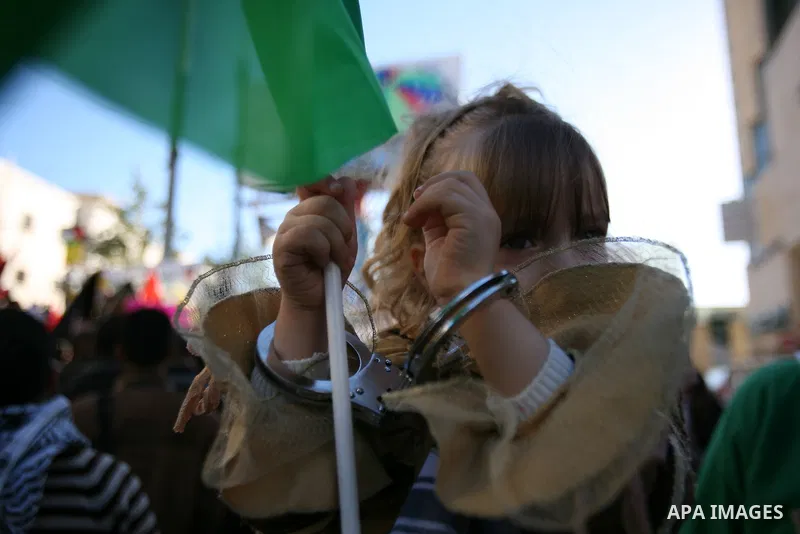 Protesters hold portraits of Samer Issawi and Ayman Sharwanah, Palestinian prisoners held in Israeli jails and on hunger strike, during a solidarity protest in the West Bank city of Hebron, December 12, 2012. Demonstrato...