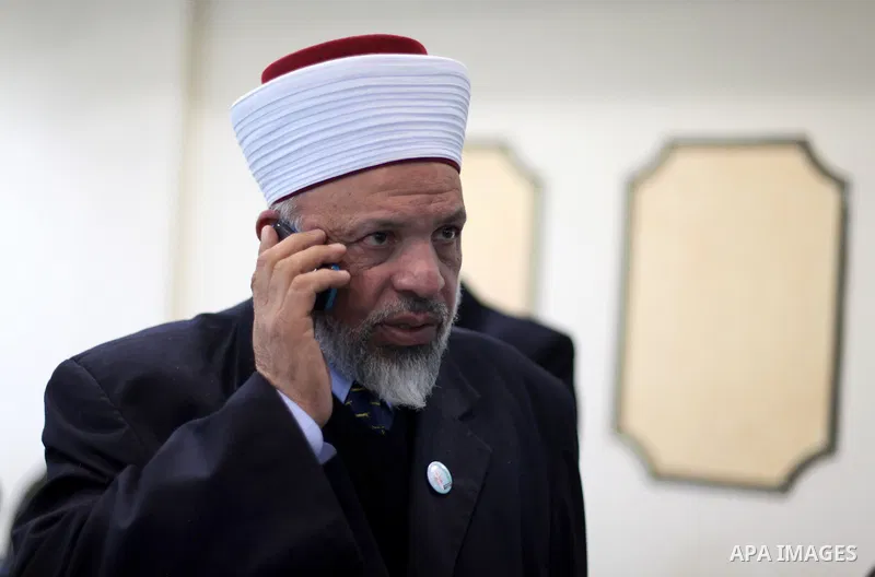 Sheikh Taysir Tamimi, talks on the phone during a press conference in the West Bank city of Ramallah, 12 December 2012, where he announced the launch of his political party in the Palestinian "Freedom and Independence Pa...