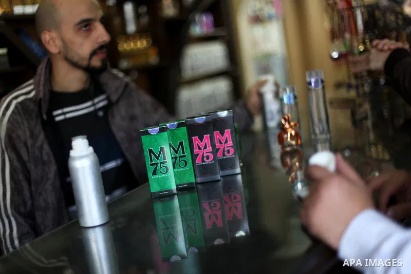 A Palestinian vendor displays perfume bottles called M75 at his shop in Gaza City December 12, 2012. The Gaza vendor said the new perfume symbolises the name of the home-made M75 rocket. Hamas' armed wing said they had f...