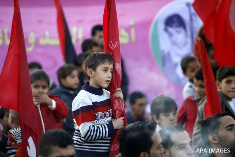 Supporters of the Popular Front for the Liberation of Palestine (PFLP) carry the party flag during a rally to mark the 45th anniversary of the founding of the PFLP in Khan Younis southern Gaza strip, December 12, 2012. P...