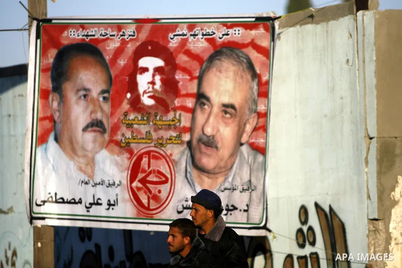 Supporters of the Popular Front for the Liberation of Palestine (PFLP) carry the party flag during a rally to mark the 45th anniversary of the founding of the PFLP in Khan Younis southern Gaza strip, December 12, 2012. P...