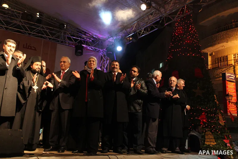 Palestinian prime minister Salam Fayyad attends a celebration by Palestinian Christians and Muslims to inaugurate Christmas' decorations in the West Bank city of Ramallah, on December 12, 2012. Photo by Issam Rimawi