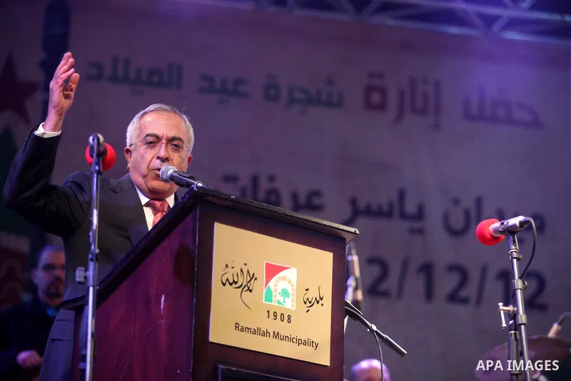 Palestinian prime minister Salam Fayyad attends a celebration by Palestinian Christians and Muslims to inaugurate Christmas' decorations in the West Bank city of Ramallah, on December 12, 2012. Photo by Issam Rimawi