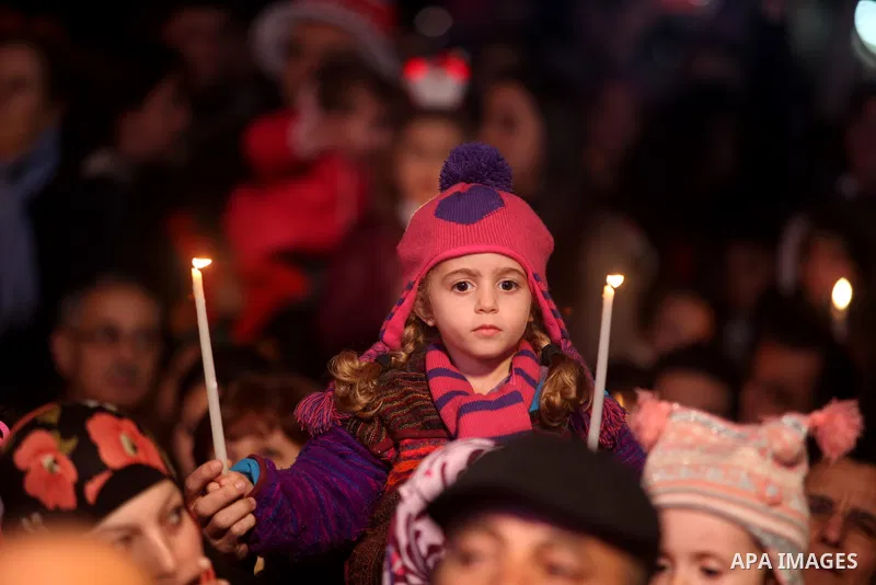 Palestinians participate a celebration by Palestinian Christians and Muslims to inaugurate Christmas' decorations in the West Bank city of Ramallah, on December 12, 2012. Photo by Issam Rimawi