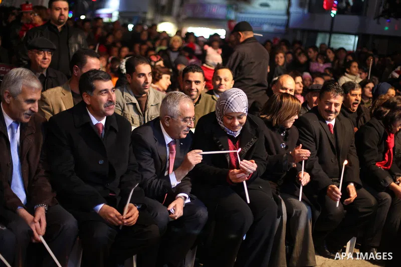 Palestinian prime minister Salam Fayyad attends a celebration by Palestinian Christians and Muslims to inaugurate Christmas' decorations in the West Bank city of Ramallah, on December 12, 2012. Photo by Issam Rimawi