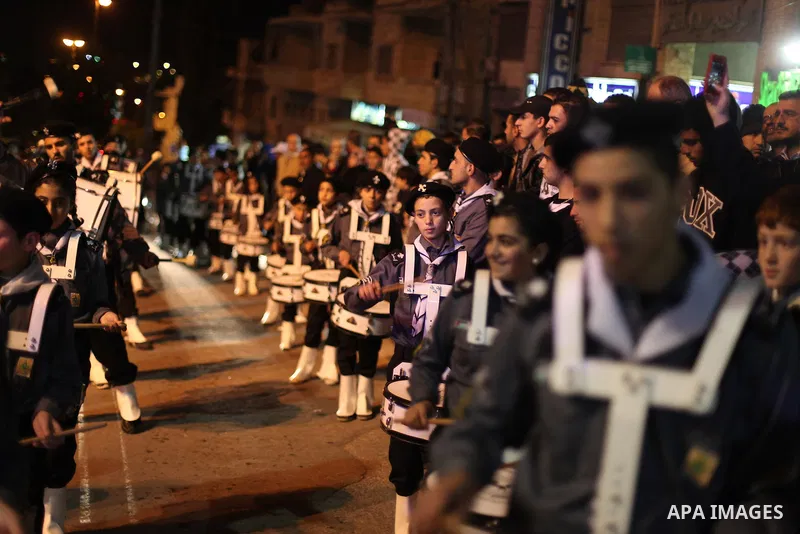 Palestinians participate a celebration by Palestinian Christians and Muslims to inaugurate Christmas' decorations in the West Bank city of Ramallah, on December 12, 2012. Photo by Issam Rimawi