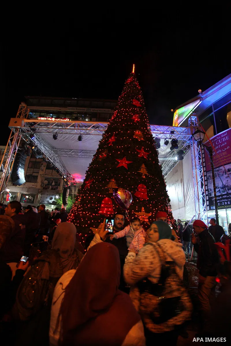 Palestinians participate a celebration by Palestinian Christians and Muslims to inaugurate Christmas' decorations in the West Bank city of Ramallah, on December 12, 2012. Photo by Issam Rimawi