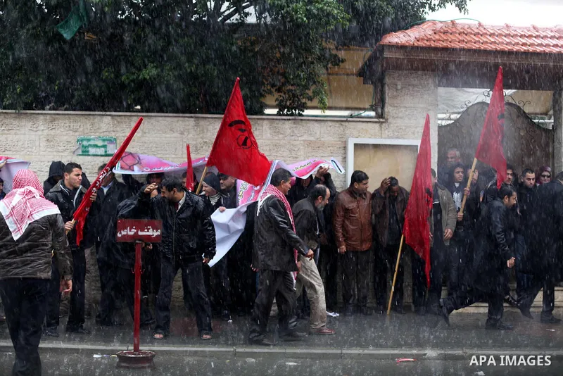 Supporters of Democratic Front for the Liberation of Palestine (DFLP) hold flags and portraits of Palestinian prisoners held in Israeli jails during a rally calling for their release, in Gaza city on Dec. 13, 2012. Photo...