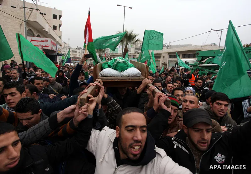 Palestinians carry the body of teenager Mohammed Ziad Salaymeh during his funeral in the West Bank city of Hebron, 13 December 2012. Israeli border police in the divided West Bank city of Hebron on 12 December shot dead...