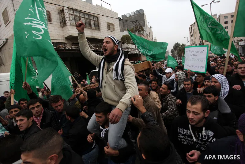 Palestinians carry the body of teenager Mohammed Ziad Salaymeh during his funeral in the West Bank city of Hebron, 13 December 2012. Israeli border police in the divided West Bank city of Hebron on 12 December shot dead...