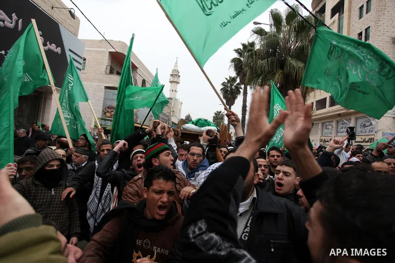 Palestinians carry the body of teenager Mohammed Ziad Salaymeh during his funeral in the West Bank city of Hebron, 13 December 2012. Israeli border police in the divided West Bank city of Hebron on 12 December shot dead...