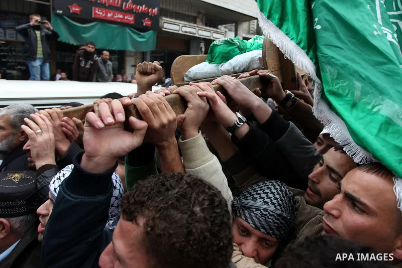 Palestinians carry the body of teenager Mohammed Ziad Salaymeh during his funeral in the West Bank city of Hebron, 13 December 2012. Israeli border police in the divided West Bank city of Hebron on 12 December shot dead...