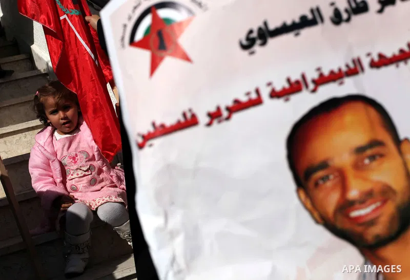 Palestinian women hold flags and portraits of Palestinian prisoners held in Israeli jails during a rally calling for their release, in Gaza city on Dec. 15, 2012. Photo by Ashraf Amra