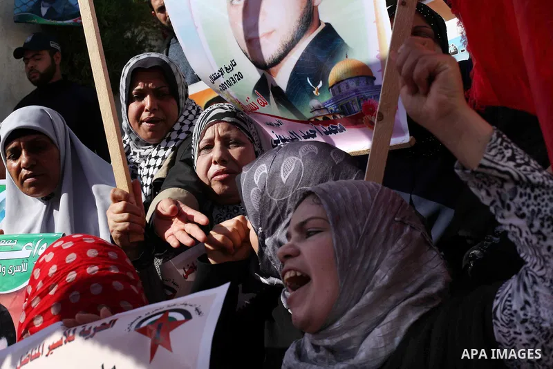 Palestinian women hold flags and portraits of Palestinian prisoners held in Israeli jails during a rally calling for their release, in Gaza city on Dec. 15, 2012. Photo by Ashraf Amra