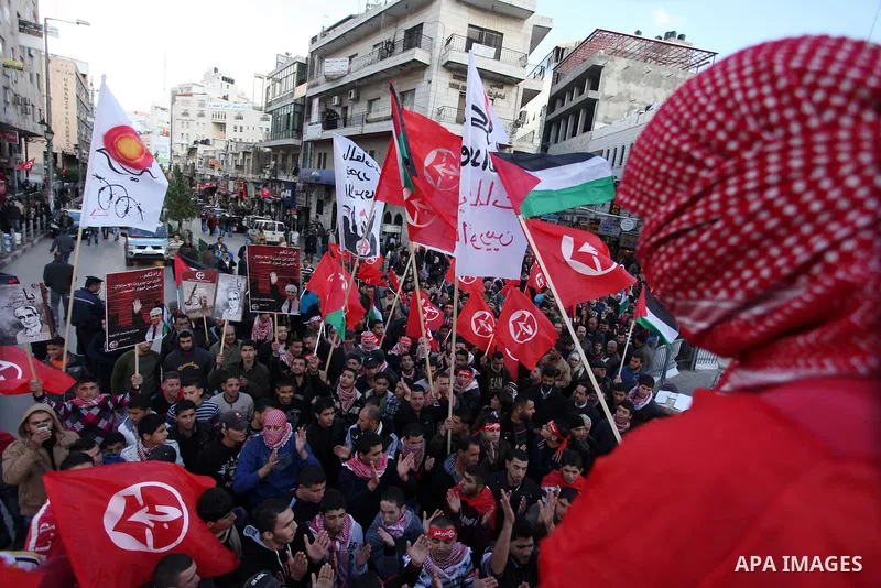 Palestinians wave flags during a rally marking the 45th anniversary of the Popular Front for the Liberation of Palestine (PFLP), in the West Bank city of Ramallah, Saturday, Dec. 15, 2012. Photo by Issam Rimawi