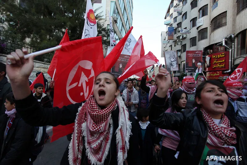 Palestinians wave flags during a rally marking the 45th anniversary of the Popular Front for the Liberation of Palestine (PFLP), in the West Bank city of Ramallah, Saturday, Dec. 15, 2012. Photo by Issam Rimawi