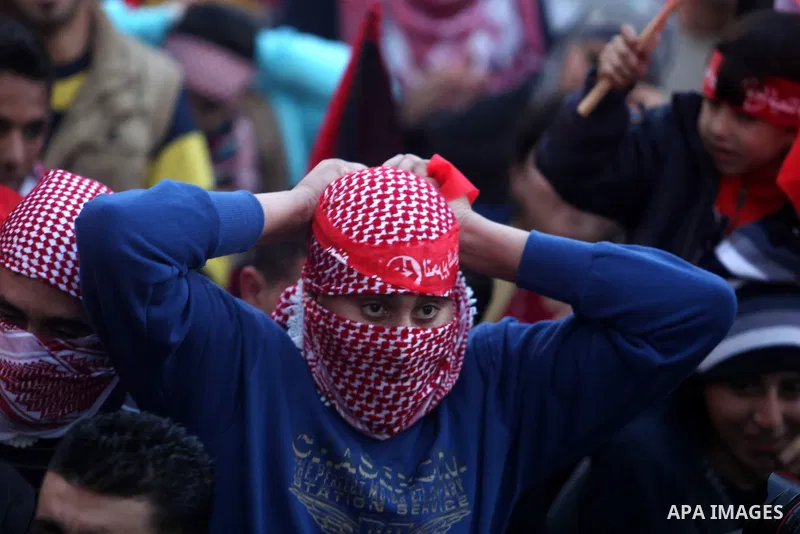 Palestinians wave flags during a rally marking the 45th anniversary of the Popular Front for the Liberation of Palestine (PFLP), in the West Bank city of Ramallah, Saturday, Dec. 15, 2012. Photo by Issam Rimawi