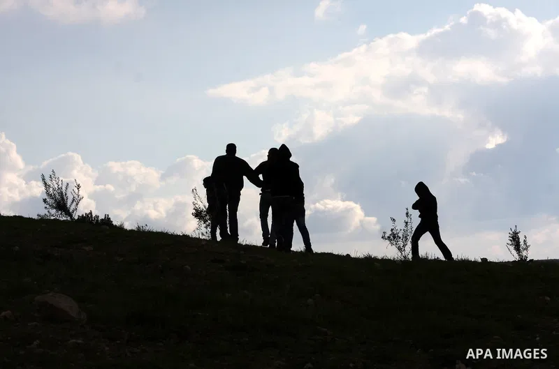 Palestinian protesters uses a slingshot to throw stones at Israeli soldiers after an attack by Israeli settlers on Palestinian homes in village of Urif near the west bank city of Nablus on Dec. 15, 2012 . Photo by Nedal...