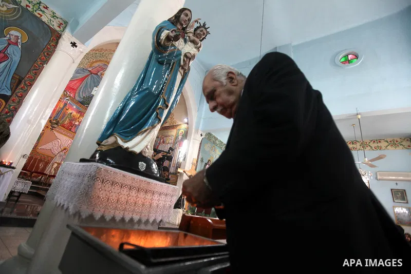 A Palestinian Christian attends a prayers at the Latin Catholic Church in Gaza City, Sunday, Dec. 16, 2012. Twal arrived in Gaza on Sunday to attend a celebration with Palestinians ahead of Christmas. Photo by Majdi Fath...