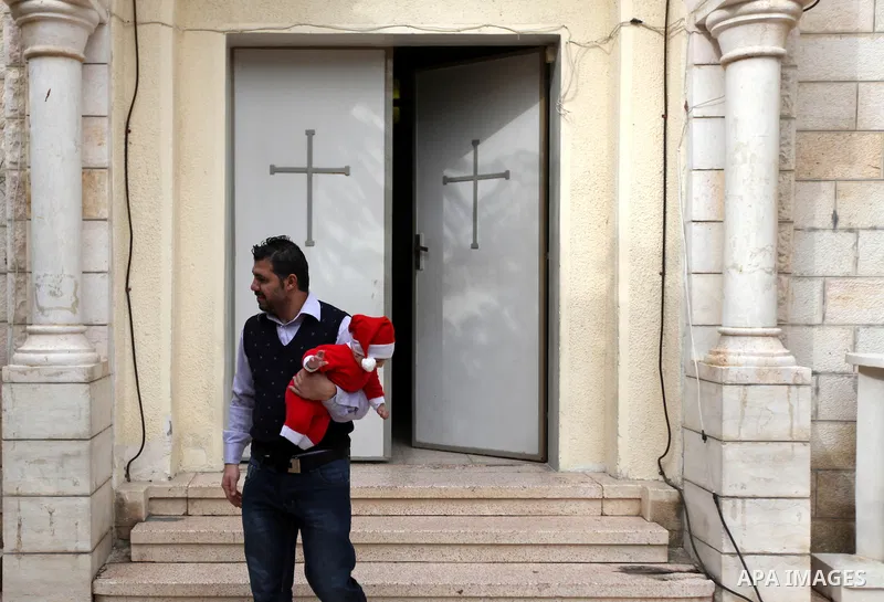 A Palestinian Christian attends a prayers at the Latin Catholic Church in Gaza City, Sunday, Dec. 16, 2012. Twal arrived in Gaza on Sunday to attend a celebration with Palestinians ahead of Christmas. Photo by Majdi Fath...