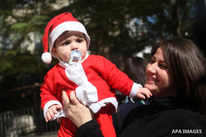 Palestinian child dressed as Pope Claus during visiting Latin Patriarch of Jerusalem Fouad Twal in Gaza City, Sunday, Dec. 16, 2012. Twal arrived in Gaza on Sunday to attend a celebration with Palestinians ahead of Chris...