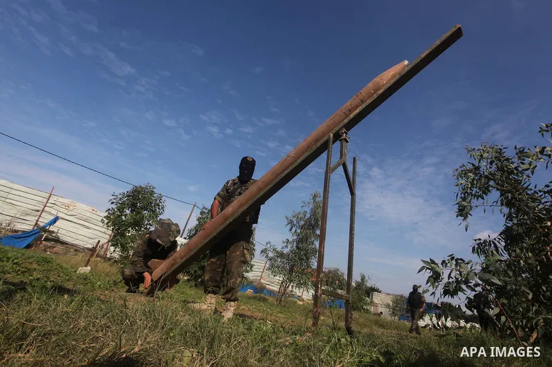 Palestinian militants from al-Quds Brigades the armed wing of the Islamic Jihad organization, stand around a rocket launcher during military exercises at an undisclosed location in the Hamas-run Gaza Strip in Gaza city o...