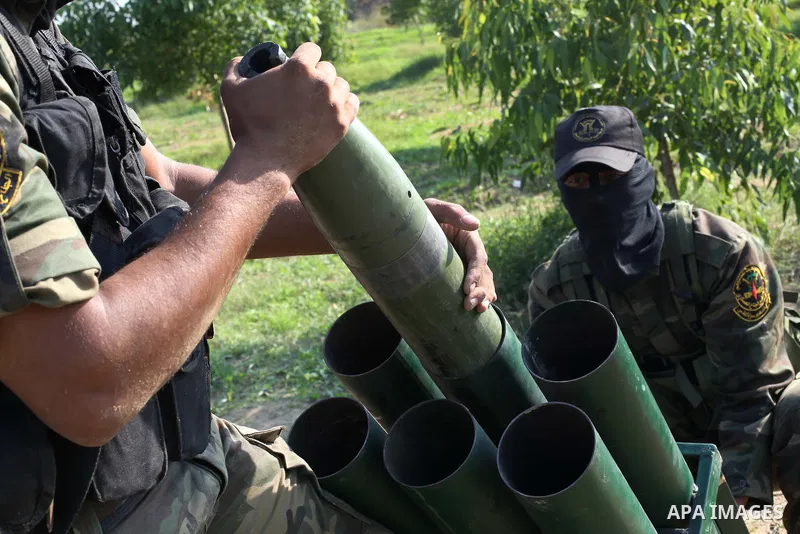 Palestinian militants from al-Quds Brigades the armed wing of the Islamic Jihad organization, sit around a rocket launcher during military exercises at an undisclosed location in the Hamas-run Gaza Strip in Gaza city on...
