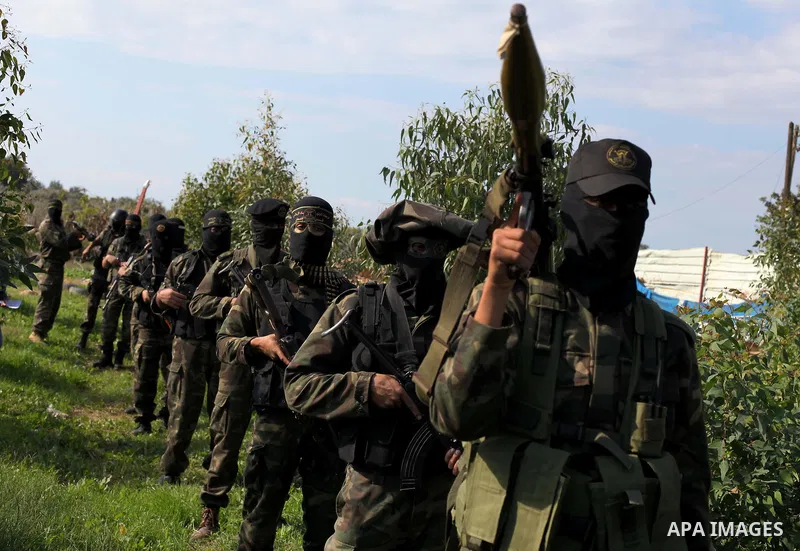 Palestinian militants from al-Quds Brigades the armed wing of the Islamic Jihad, stand during military exercises at an undisclosed location in the Hamas-run Gaza Strip in Gaza city on Dec 16. 2012. Hamas' armed wing and...