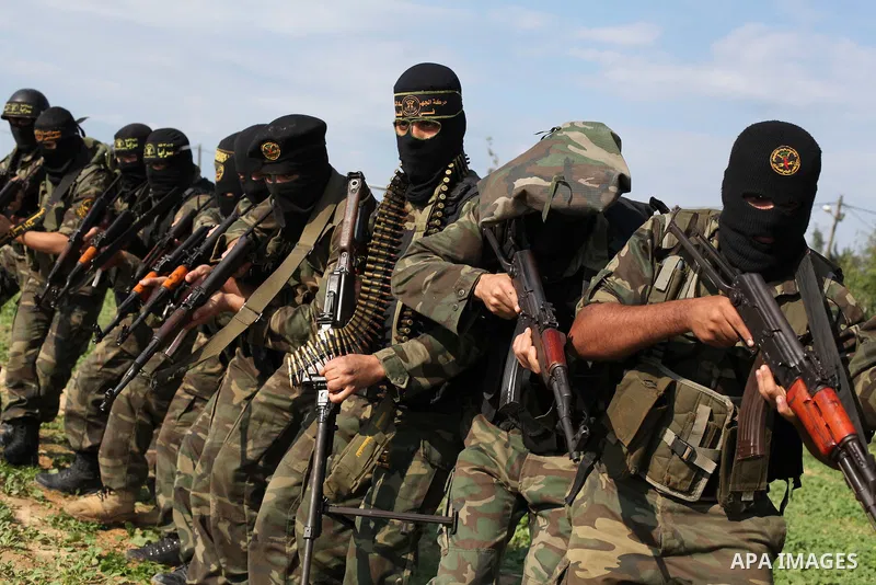 Palestinian militants from al-Quds Brigades the armed wing of the Islamic Jihad organization, walk during military exercises at an undisclosed location in the Hamas-run Gaza Strip in Gaza city on Dec 16. 2012. Hamas' arm...
