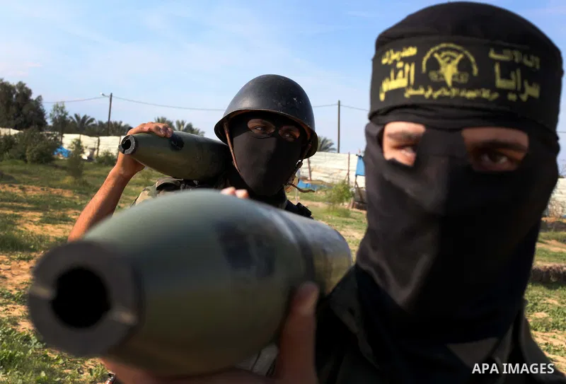 Palestinian militants from al-Quds Brigades the armed wing of the Islamic Jihad organization, carry rockets during military exercises at an undisclosed location in the Hamas-run Gaza Strip in Gaza city on Dec 16. 2012. H...