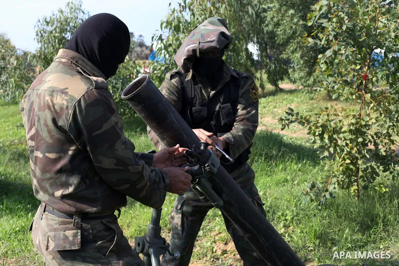 Palestinian militants from al-Quds Brigades the armed wing of the Islamic Jihad organization, stand around a rocket launcher during military exercises at an undisclosed location in the Hamas-run Gaza Strip in Gaza city o...