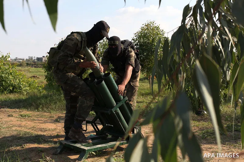 Palestinian militants from al-Quds Brigades the armed wing of the Islamic Jihad organization, stand around a rocket launcher during military exercises at an undisclosed location in the Hamas-run Gaza Strip in Gaza city o...