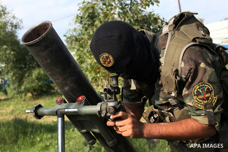 A Palestinian militant from al-Quds Brigades the armed wing of the Islamic Jihad organization, stands next to a rocket launcher during military exercises at an undisclosed location in the Hamas-run Gaza Strip in Gaza cit...
