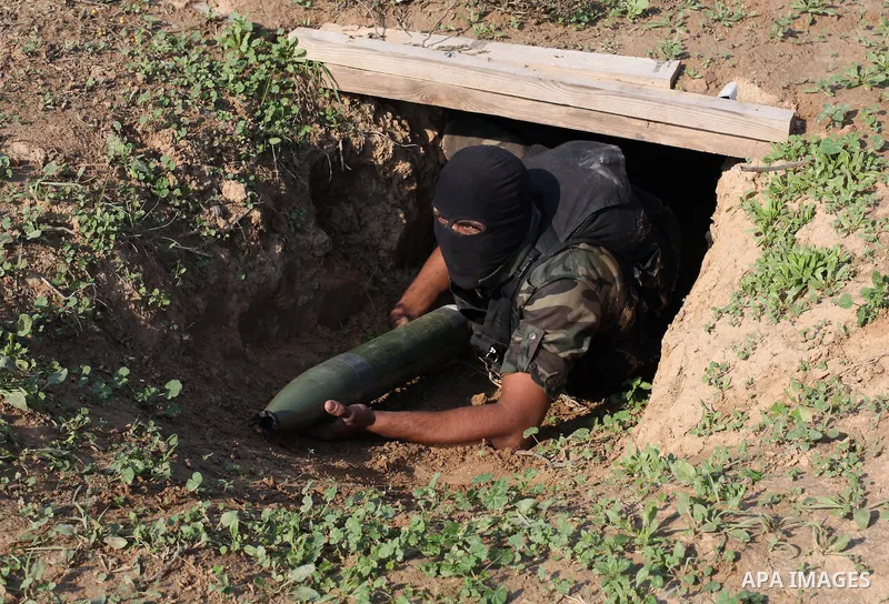 A Palestinian militant from al-Quds Brigades the armed wing of the Islamic Jihad organization, carries a rocket during military exercises at an undisclosed location in the Hamas-run Gaza Strip in Gaza city on Dec 16. 201...