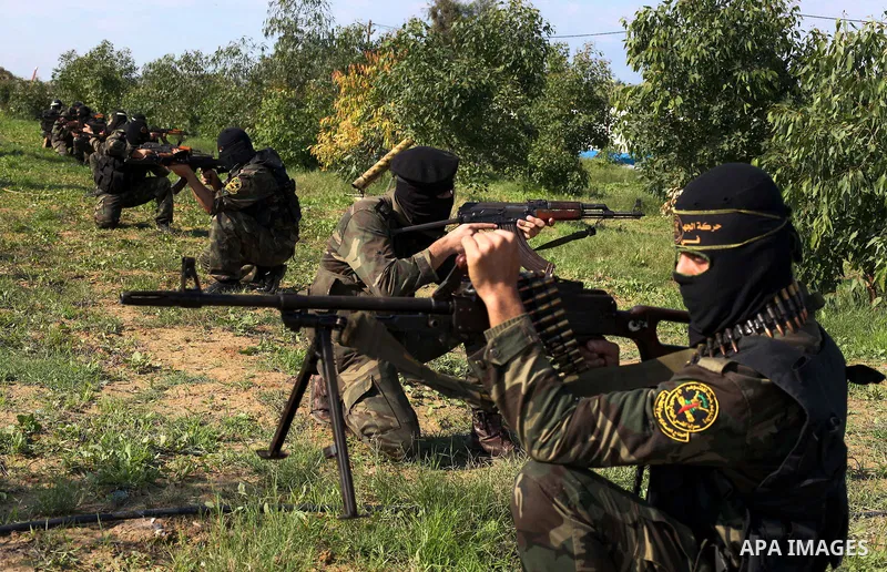 Palestinian militants from al-Quds Brigades the armed wing of the Islamic Jihad organization, sit during military exercises at an undisclosed location in the Hamas-run Gaza Strip in Gaza city on Dec 16. 2012. Hamas' arme...
