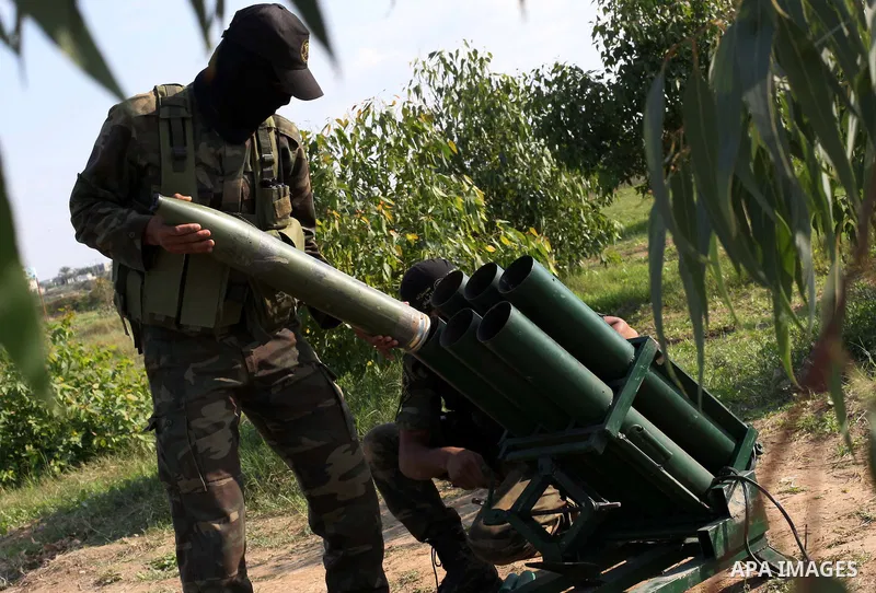 Palestinian militants from al-Quds Brigades the armed wing of the Islamic Jihad organization, stand around a rocket launcher during military exercises at an undisclosed location in the Hamas-run Gaza Strip in Gaza city o...