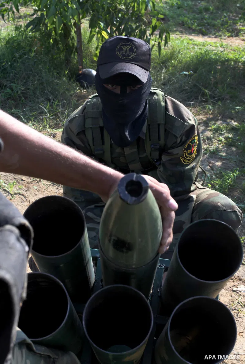 Palestinian militants from al-Quds Brigades the armed wing of the Islamic Jihad organization, stand around a rocket launcher during military exercises at an undisclosed location in the Hamas-run Gaza Strip in Gaza city o...