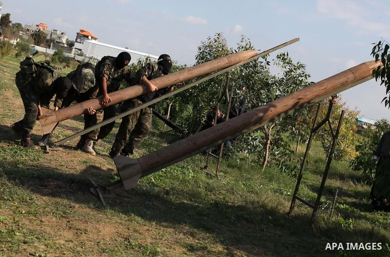 Palestinian militants from al-Quds Brigades the armed wing of the Islamic Jihad organization, stand around a rocket launcher during military exercises at an undisclosed location in the Hamas-run Gaza Strip in Gaza city o...