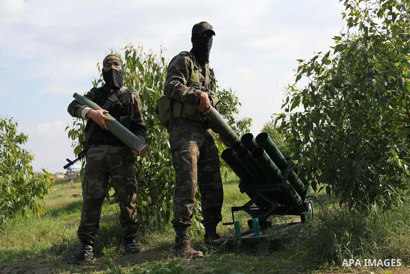 Palestinian militants from al-Quds Brigades the armed wing of the Islamic Jihad organization, stand around a rocket launcher during military exercises at an undisclosed location in the Hamas-run Gaza Strip in Gaza city o...