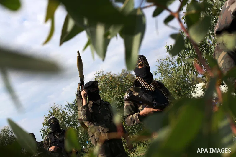 Palestinian militants from al-Quds Brigades the armed wing of the Islamic Jihad organization, walk during military exercises at an undisclosed location in the Hamas-run Gaza Strip in Gaza city on Dec 16. 2012. Hamas' arm...