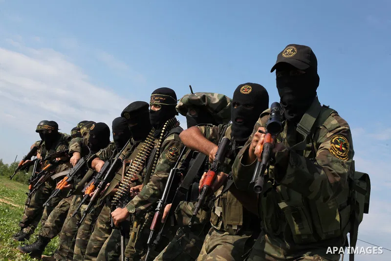 Palestinian militants from al-Quds Brigades the armed wing of the Islamic Jihad organization, walk during military exercises at an undisclosed location in the Hamas-run Gaza Strip in Gaza city on Dec 16. 2012. Hamas' arm...