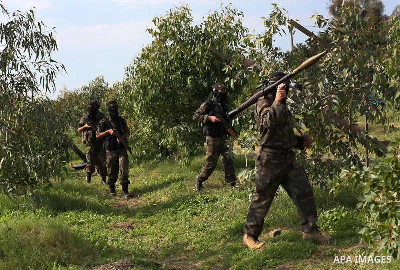 Palestinian militants from al-Quds Brigades the armed wing of the Islamic Jihad organization, walk during military exercises at an undisclosed location in the Hamas-run Gaza Strip in Gaza city on Dec 16. 2012. Hamas' arm...