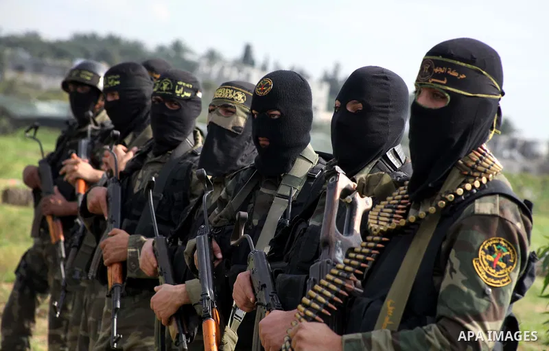 Palestinian militants from al-Quds Brigades the armed wing of the Islamic Jihad organization, stand during military exercises at an undisclosed location in the Hamas-run Gaza Strip in Gaza city on Dec 16. 2012. Hamas' ar...