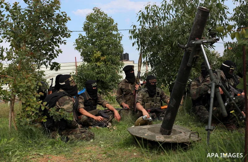 Palestinian militants from al-Quds Brigades the armed wing of the Islamic Jihad organization, stand around a rocket launcher during military exercises at an undisclosed location in the Hamas-run Gaza Strip in Gaza city o...