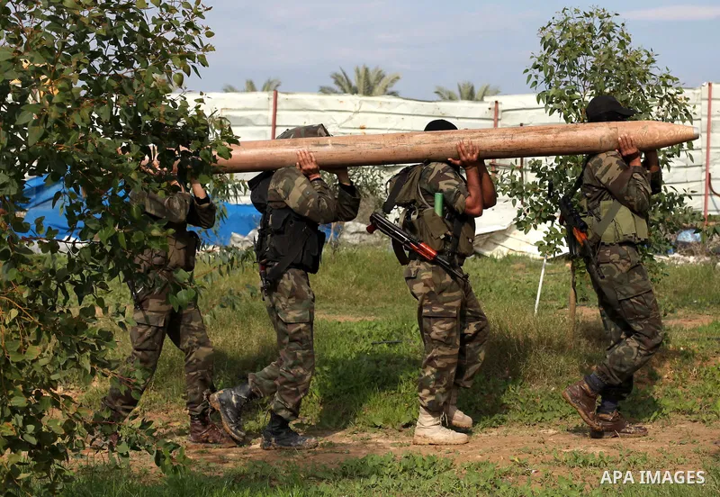 Palestinian militants from al-Quds Brigades the armed wing of the Islamic Jihad organization, carry a rocket during military exercises at an undisclosed location in the Hamas-run Gaza Strip in Gaza city on Dec 16. 2012....